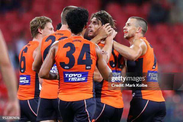 Ryan Griffen of the Giants celebrates with his team mates after kicking a goal during the round six AFL match between the Greater Western Sydney...