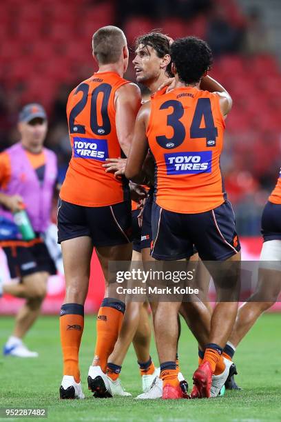 Ryan Griffen of the Giants celebrates with his team mates after kicking a goal during the round six AFL match between the Greater Western Sydney...