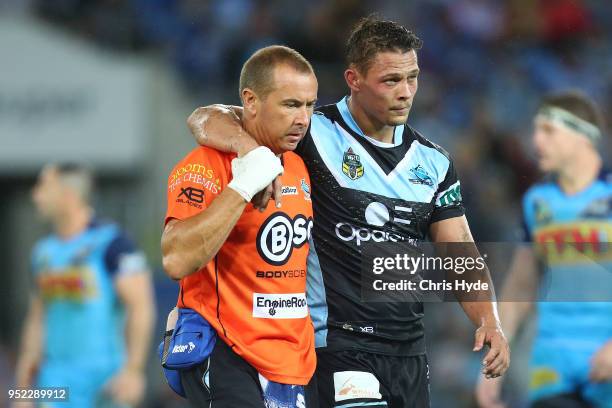 Scott Sorensen of the Sharks leaves the field injured during the round eight NRL match between the Gold Coast Titans and Cronulla Sharks at Cbus...