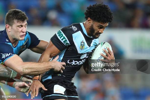 Ricky Leutele of the Sharks is tackled during the round eight NRL match between the Gold Coast Titans and Cronulla Sharks at Cbus Super Stadium on...
