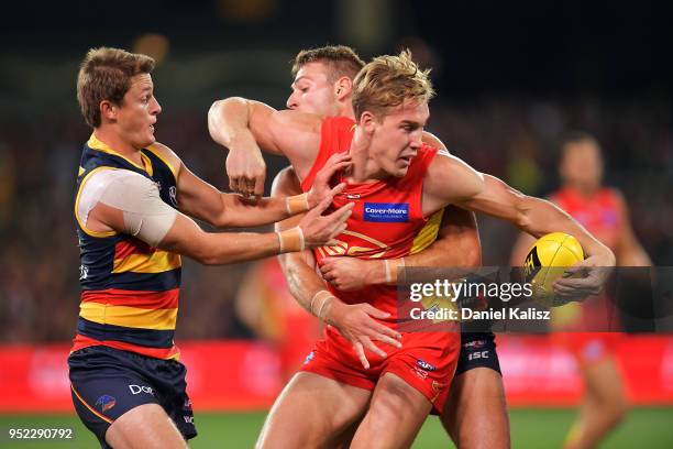Tom Lynch of the Suns is tackled by Josh Jenkins of the Crows during the round six AFL match between the Adelaide Crows and Gold Coast Suns at...