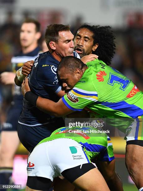 Scott Bolton of the Cowboys is wrapped up by the Raiders defence during the round eight NRL match between the North Queensland Cowboys and the...