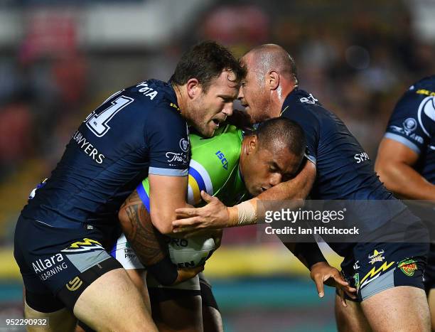 Junior Paulo of the Raiders is tackled by Gavin Cooper and Matthew Scott of the Cowboys during the round eight NRL match between the North Queensland...
