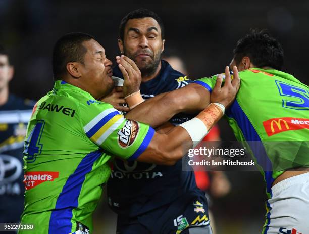 Justin O'Neil of the Cowboys is tackled by Joseph Leilua and Jordan Rapana of the Raiders during the round eight NRL match between the North...