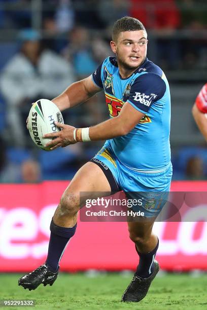 Ash Taylor of the Titans runs the ball during the round eight NRL match between the Gold Coast Titans and Cronulla Sharks at Cbus Super Stadium on...