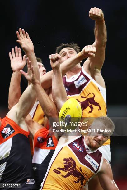 Oscar McInerney and Nick Robertson of the Lions compete against Jonathon Patton of the Giants during the round six AFL match between the Greater...