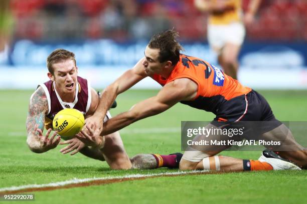 Dayne Beams of the Lions is challenged by Jeremy Finlayson of the Giants during the round six AFL match between the Greater Western Sydney Giants and...