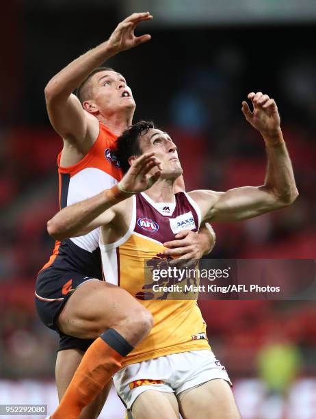 Oscar McInerney of the Lions competes for the ball against Adam Tomlinson of the Giants during the round six AFL match between the Greater Western...