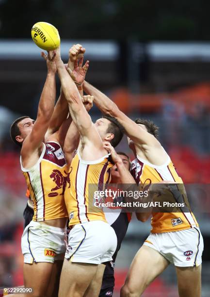 Cameron Rayner, Stefan Martin and Oscar McInerney of the Lions compete for the ball during the round six AFL match between the Greater Western Sydney...