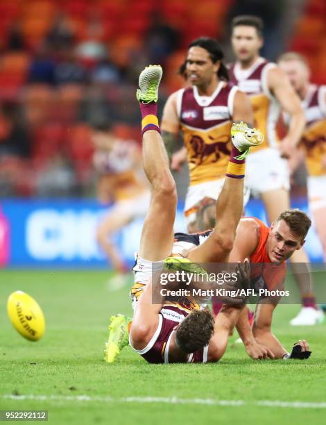 Tom Cutler of the Lions is challenged by Zac Langdon of the Giants during the round six AFL match between the Greater Western Sydney Giants and the...