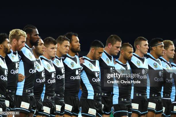 Sharks look on during the National anthem during the round eight NRL match between the Gold Coast Titans and Cronulla Sharks at Cbus Super Stadium on...