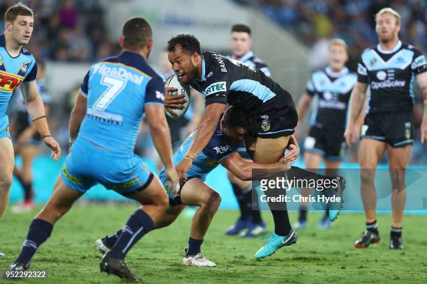 Joseph Paulo of the Sharks is tackled during the round eight NRL match between the Gold Coast Titans and Cronulla Sharks at Cbus Super Stadium on...