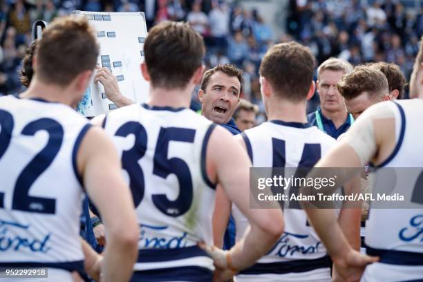 Chris Scott, Senior Coach of the Cats addresses his players during the 2018 AFL round six match between the Geelong Cats and the Sydney Swans at...