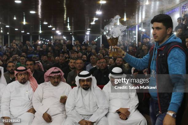 Incense is being spread among attendees during a rare levant goat auction and exhibition on April 2018, in Amman, Jordan. Animal breeders...