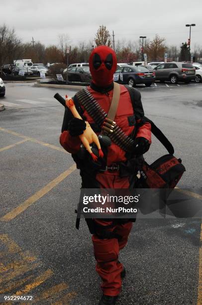 Cosplayer dressed as Dead Pool greats fans with a rubber chicken mimicking the Marvel charters snese of fun and funny at The Great Philadelphia Comic...