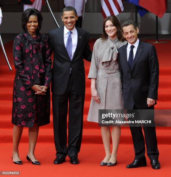 President Barack Obama with US first lady Michelle Obama, France's President Nicolas Sarkozy and France's first lady Carla Bruni-Sarkozy pose during...