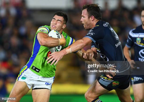 Nikola Cotric of the Raiders is tackled by Gavin Cooper of the Cowboys during the round eight NRL match between the North Queensland Cowboys and the...