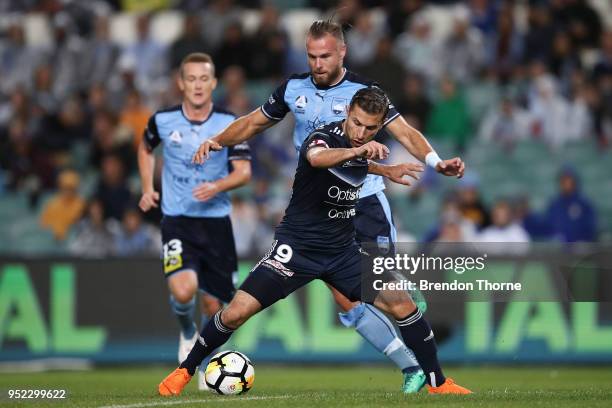 Kosta Barbarouses of the Victory competes with Jordy Buijs of Sydney during the A-League Semi Final match between Sydney FC and Melbourne Victory at...