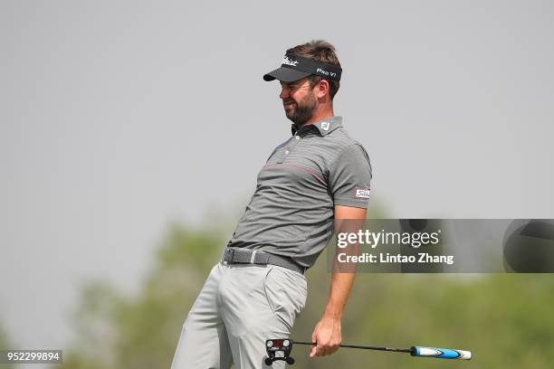 Scott Jamieson of Scotland reacts after the plays a shot during the day three of the 2018 Volvo China Open at Topwin Golf and Country Club on April...