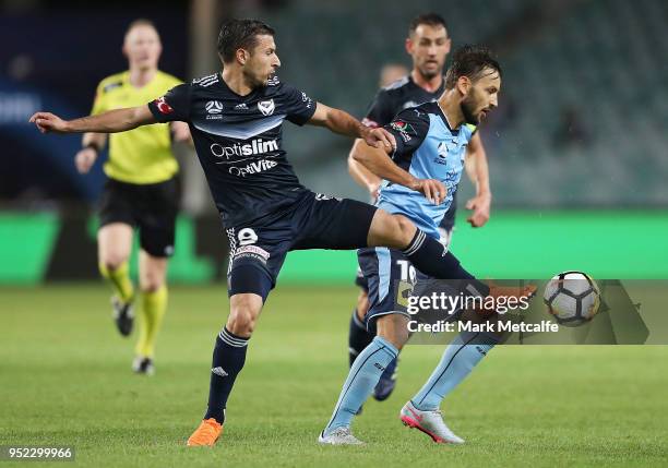 Milos Ninkovic of Sydney FC is challenged by Kosta Barbarouses of the Victory during the A-League Semi Final match between Sydney FC and Melbourne...