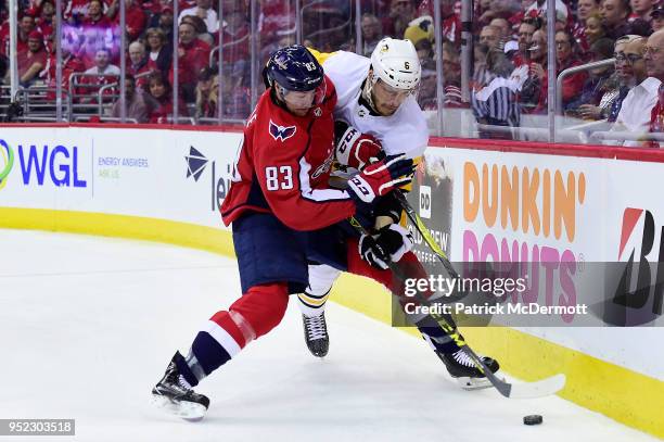 Jay Beagle of the Washington Capitals and Jamie Oleksiak of the Pittsburgh Penguins battle for the puck in the first period in Game One of the...