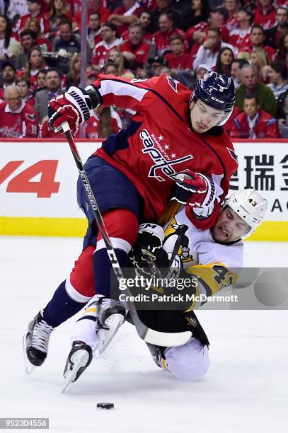 Dmitry Orlov of the Washington Capitals and Conor Sheary of the Pittsburgh Penguins battle for the puck in the second period in Game One of the...