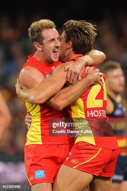 Michael Barlow of the Suns celebrates with David Swallow of the Suns during the round six AFL match between the Adelaide Crows and Gold Coast Suns at...