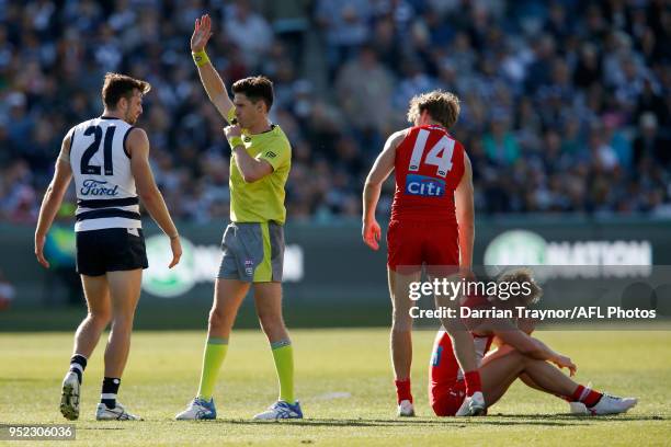 Jordan Murdoch of the Cats is put on report after colliding with Isaac Heeney of the Swans during the round six AFL match between the Geelong Cats...