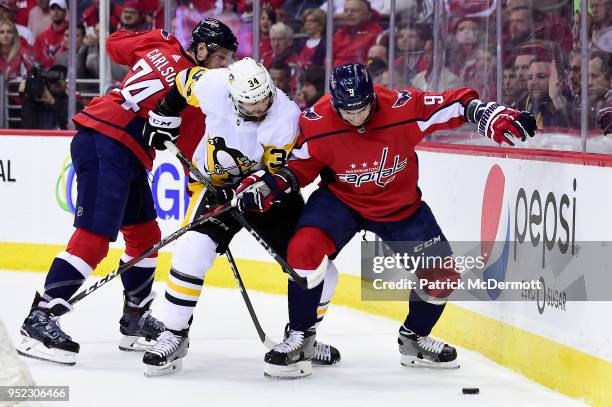 Dmitry Orlov of the Washington Capitals and Tom Kuhnhackl of the Pittsburgh Penguins battle for the puck in the second period in Game One of the...