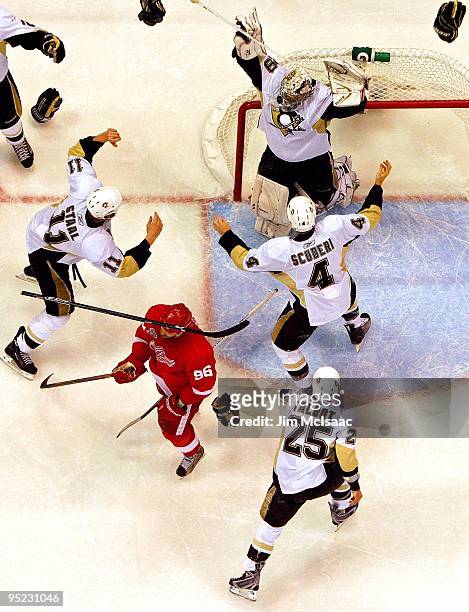 Jordan Staal, Maxime Talbot, Rob Scuderi and Marc-Andre Fleury of the Pittsburgh Penguins celebrate after defeating the Detroit Red Wings by a score...