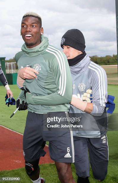 Paul Pogba and Joel Pereira of Manchester United in action during a first team training session at Aon Training Complex on April 28, 2018 in...