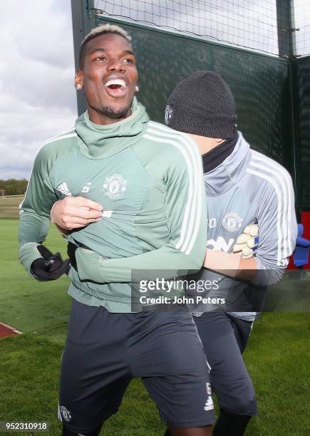 Paul Pogba and Joel Pereira of Manchester United in action during a first team training session at Aon Training Complex on April 28, 2018 in...