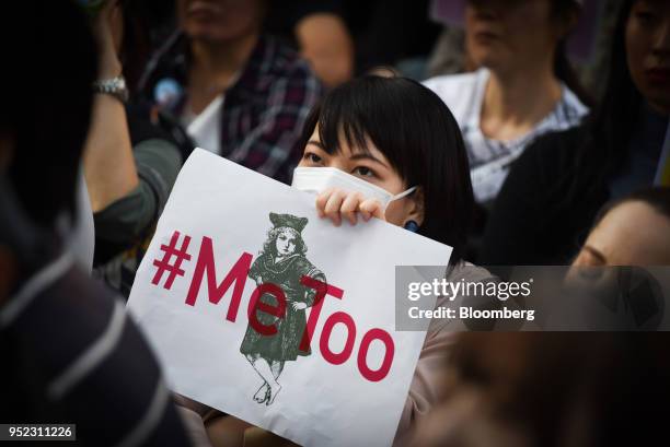 Demonstrator holds a sign reading "#Me Too" during a rally against sexual harassment in Shinjuku, Tokyo, on Saturday, April 28, 2018. Japan's finance...