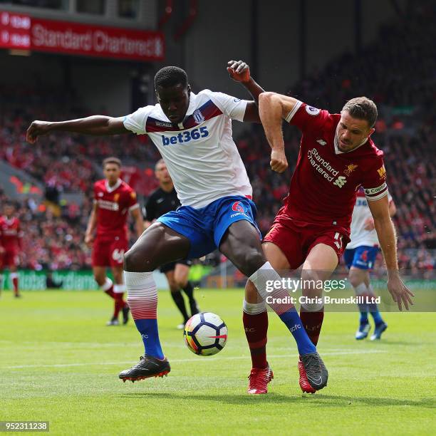 Jordan Henderson of Liverpool in action with Kurt Zouma of Stoke City during the Premier League match between Liverpool and Stoke City at Anfield on...