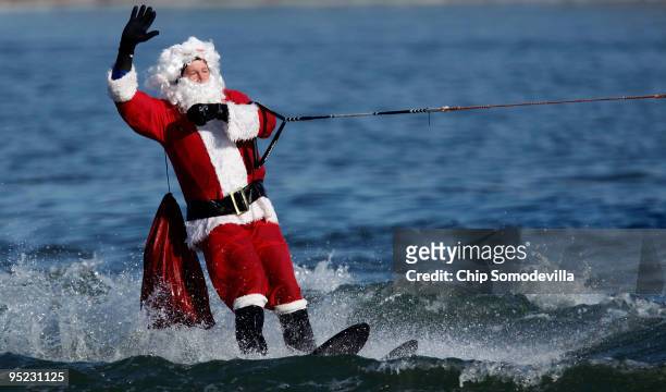 Water-Skiing Santa" cruises on the Potomac River December 24, 2009 in National Harbor, Maryland. This is the 22nd anniversary of the aquatic...