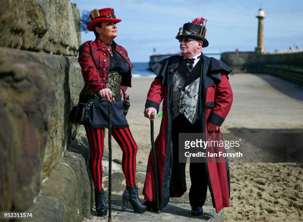 Jill McCreath and David Leonard from Darlington pose against the seawall as they attend Whitby Gothic Weekend on April 28, 2018 in Whitby, England....