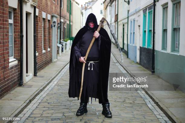 Gavin Woodward from Newcastle poses dressed as the Grim Reaper as he attends Whitby Gothic Weekend on April 28, 2018 in Whitby, England. The Whitby...