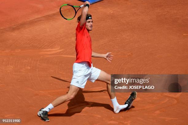 Greece's Stefanos Tsitsipas loses a shoe as he returns the ball to Spain's Pablo Carreno Busta during their Barcelona Open ATP tournament semi-final...