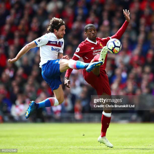 Georginio Wijnaldum of Liverpool in action with Joe Allen of Stoke City during the Premier League match between Liverpool and Stoke City at Anfield...
