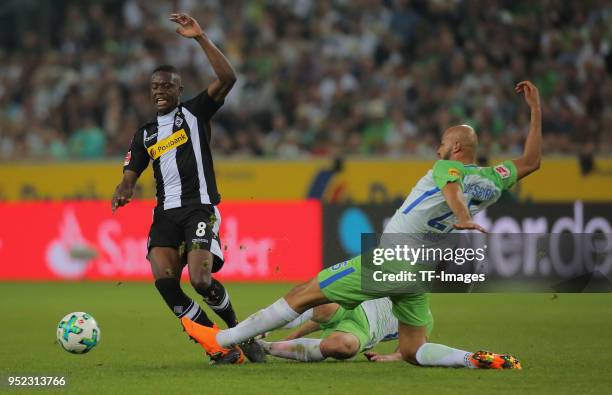 Denis Zakaria of Moenchengladbach and John Anthony Brooks of Wolfsburg battle for the ball during the Bundesliga match between Borussia...