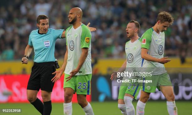 Referee Tobias Stieler, John Anthony Brooks, Maximilian Arnold and Elvis Rexhbecaj of Wolfsburg gesture during the Bundesliga match between Borussia...