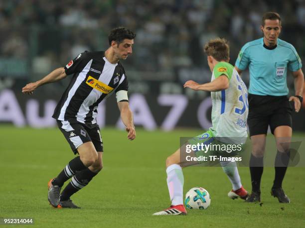 Lars Stindl of Moenchengladbach and Paul Jaeckel of Wolfsburg battle for the ball during the Bundesliga match between Borussia Moenchengladbach and...