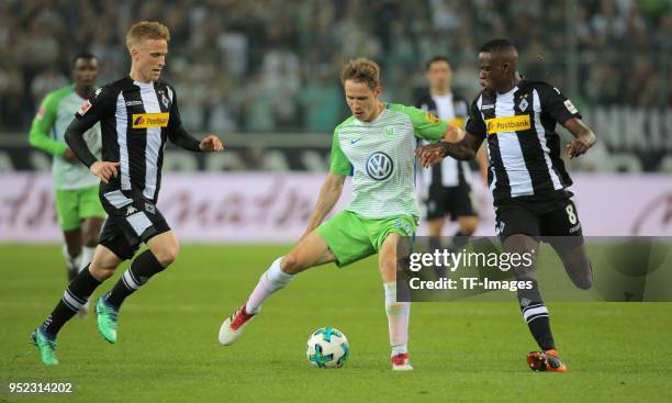 Oscar Wendt of Moenchengladbach , Paul Jaeckel of Wolfsburg and Denis Zakaria of Moenchengladbach battle for the ball during the Bundesliga match...