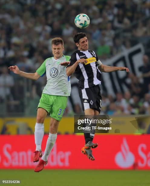 Robin Knoche of Wolfsburg and Lars Stindl of Moenchengladbach battle for the ball during the Bundesliga match between Borussia Moenchengladbach and...