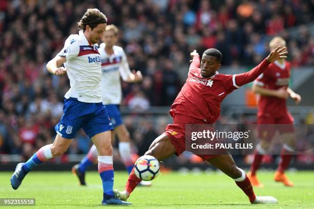 Stoke City's Welsh midfielder Joe Allen vies with Liverpool's Dutch midfielder Georginio Wijnaldum during the English Premier League football match...