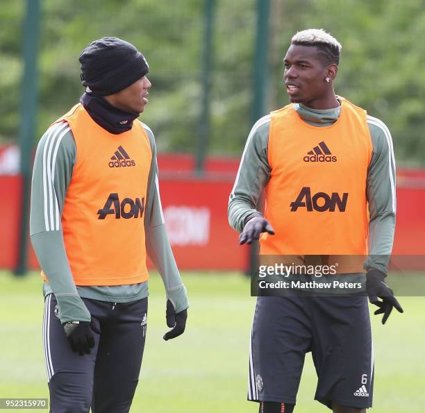 Anthony Martial and Paul Pogba of Manchester United in action during a first team training session at Aon Training Complex on April 28, 2018 in...