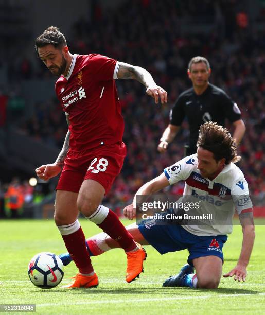 Danny Ings of Liverpool goes past Joe Allen of Stoke City during the Premier League match between Liverpool and Stoke City at Anfield on April 28,...