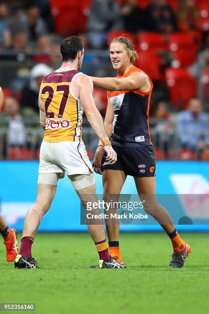 Darcy Gardiner of the Lions and Harrison Himmelberg of the Giants exchange heated words during the round six AFL match between the Greater Western...