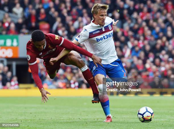 Joe Gomez of Liverpool with Moritz Bauer of Stoke City during the Premier League match between Liverpool and Stoke City at Anfield on April 28, 2018...