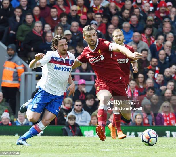 Jordan Henderson of Liverpool withJoe Allen Of Stoke City during the Premier League match between Liverpool and Stoke City at Anfield on April 28,...